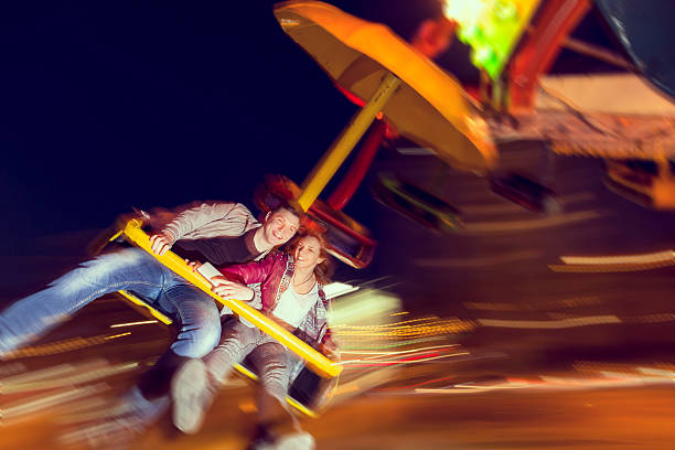 joy - blurred motion amusement park spinning lighting equipment photos et images de collection