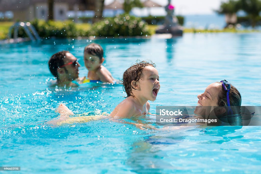 In pool Woman teaching her son how to swim Swimming Pool Stock Photo