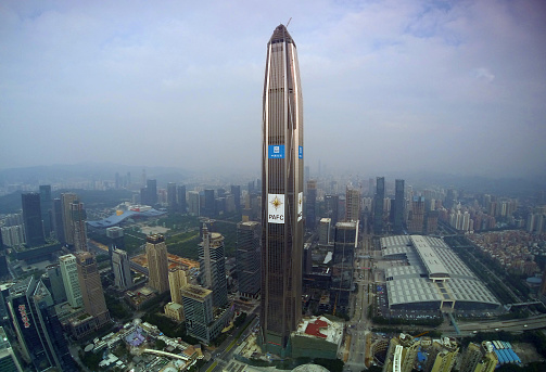 Shenzhen, Сhina - November 5, 2015: Ping An International Finance Centre building (also known as the Ping An IFC) 115-story skyscraper under construction expected to be completed in 2016, and will at that time be the 4th tallest building in the world in Coco park shopping mall downtown Shenzhen, Guangdong province, November 5, 2015. 
