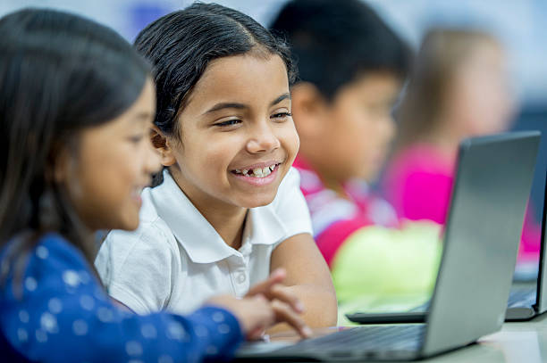 istock Little Girls Laughing While Watching a Video 496607074