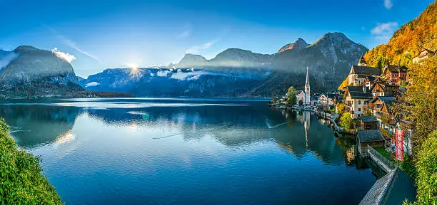 Scenic panoramic picture-postcard view of famous Hallstatt mountain village with Hallstatter See in the Austrian Alps in beautiful golden morning light in fall, Salzkammergut, Austria