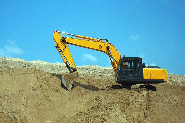 istock Yellow excavator, excavation work at a construction site. 496611010