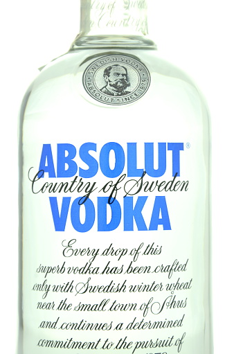 Kwidzyn, Poland - April 9, 2015: Absolut vodka isolated on white background. Absolut vodka has been produced in southern Sweden since 1879. Absolut was bought by French group Pernod Ricard in 2008