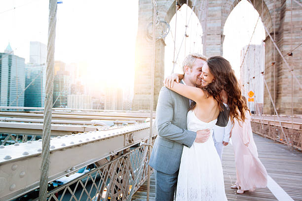istock Young couple kissing on Brooklyn Bridge 496611914