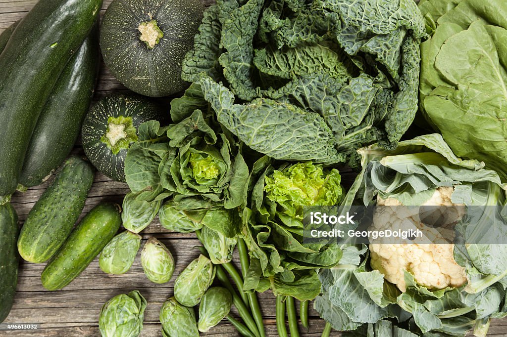 Assortment of green vegetables Assortment of green vegetables on wooden surface 2015 Stock Photo