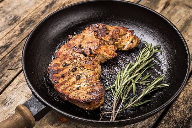 istock Roasted beefsteak with bunch of rosemary on grill pan 496614130