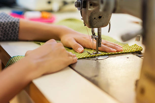 istock Young woman with sewing machine 496614200