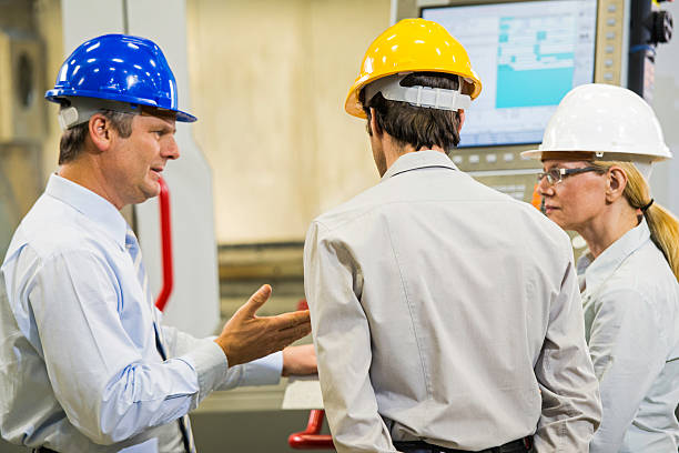 istock Manager and Two Engineers in the Factory Disscusing Project 496617323