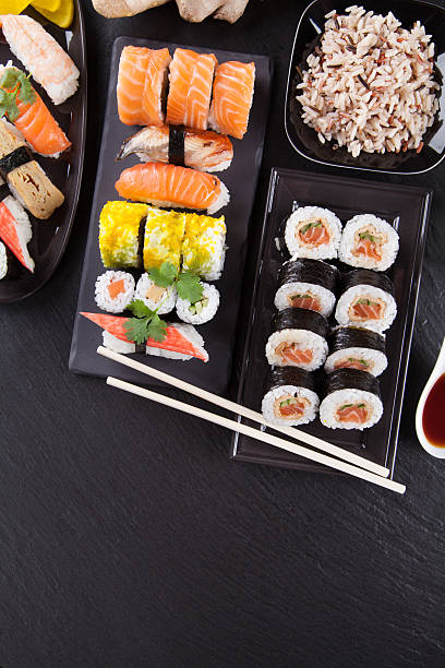 istock Delicious sushi pieces served on black stone 496617451
