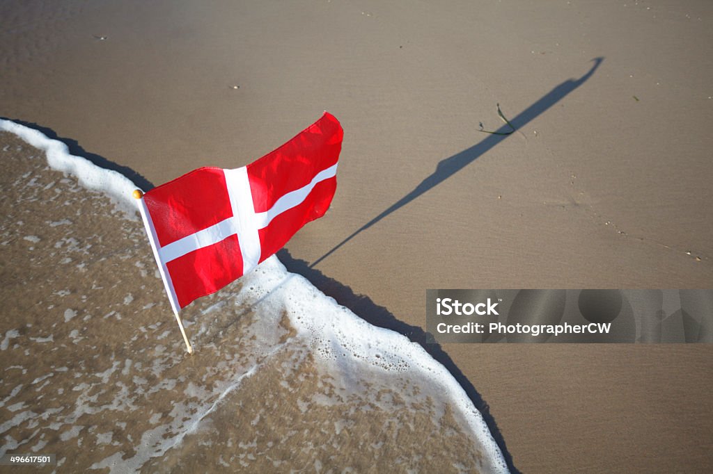 Danish flag at the west coast of Jutland Danish flag in the wind at the west coast of Jutland near Loenstrup. Danish Flag Stock Photo