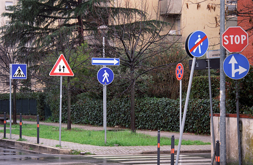 Pisa, Italy: a road junction particularly packed with road signs. Scan of Ektar 100 film