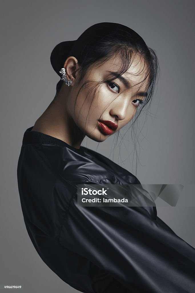 Asian beauty Portrait of fashionable asian woman wearing leather top and statement ear cuff. Professional make-up and hairstyle. High-end retouch. Fashion Model Stock Photo