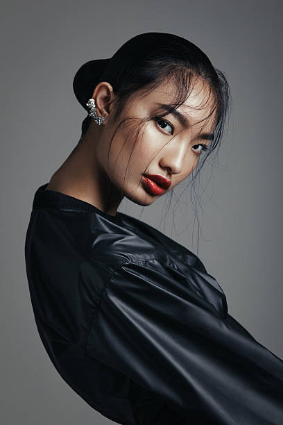 Asian beauty Portrait of fashionable asian woman wearing leather top and statement ear cuff. Professional make-up and hairstyle. High-end retouch. asian american model stock pictures, royalty-free photos & images