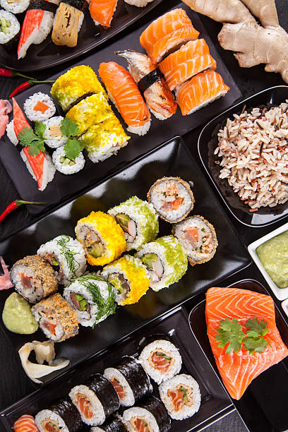 istock Delicious sushi pieces served on black stone 496619877