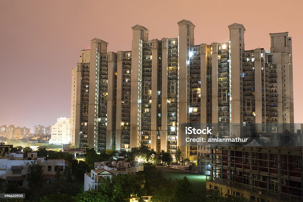 Apartments in Gurgaon Highrise multistory apartments in Gurgaon India provide homes to much of the  city's populationBalcony facing a highrise apartment building. These provide much of Gurgaon's housing solution Built Structure Stock Photo