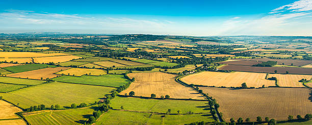 istock Patchwork quilt landscape of farm fields crops pasture aerial panorama 496622333