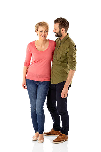 istock Beautiful young couple standing together on white 496622425