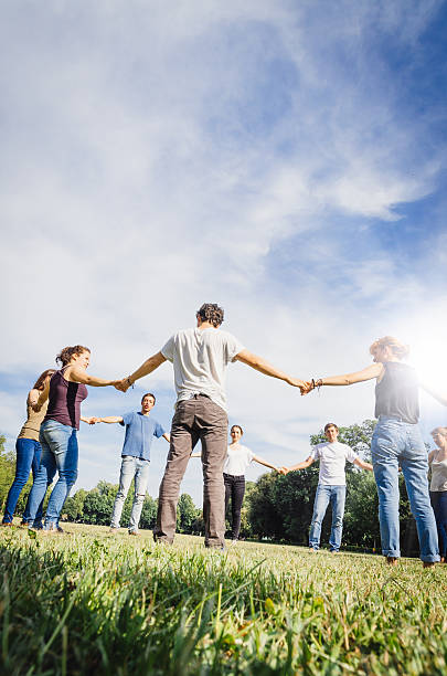 istock Friends holding hands in the park 496623081