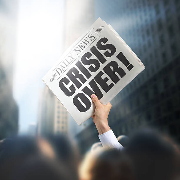 Holding Newspaper with Crisis Over