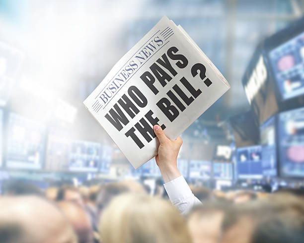 istock Holding Newspaper Who pays Bill 496623423