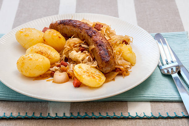 Two types of bratwurst sausage on a plate with potatoes, beets.  Norwegian cuisine.