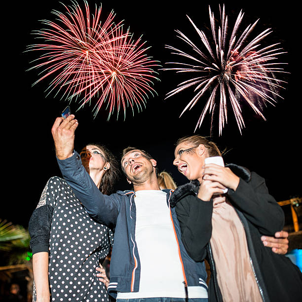 istock Happy couple embracing and looking the fireworks 496627730