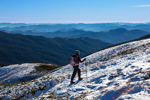 istock One Hiker Walking on Snow Ice Terrain Wide Mountain View 496629414