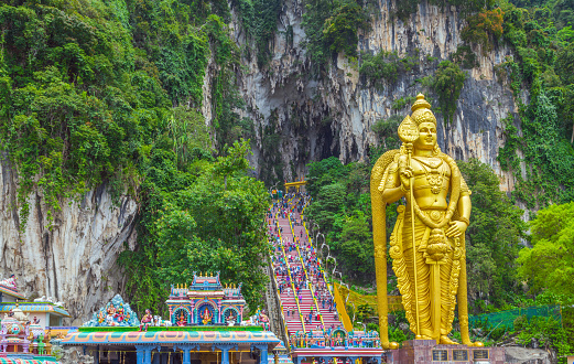 Batu Caves Lord Murugan Statue and entrance near Kuala Lumpur Malaysia. A limestone outcrop located just north of Kuala Lumpur, Batu Caves has three main caves featuring temples and Hindu shrines.