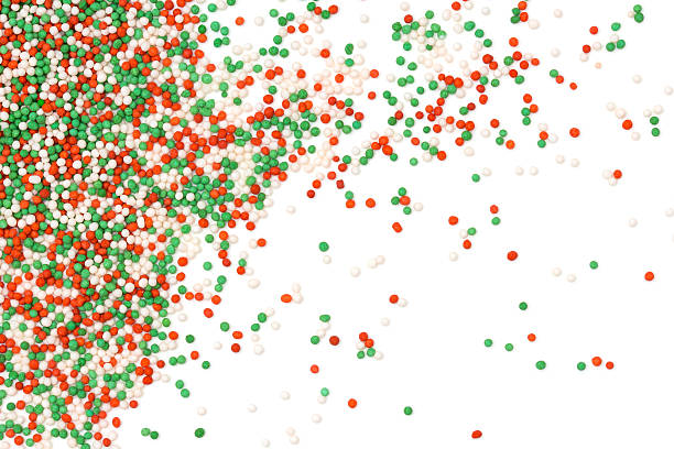 Colorful sprinkles Christmas colored sprinkles on white background. sugar sprinkles stock pictures, royalty-free photos & images