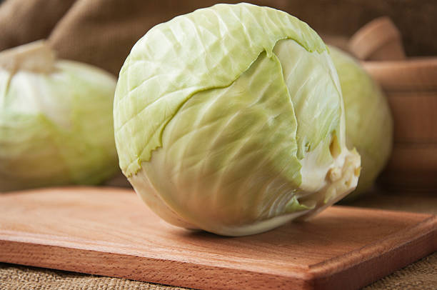 istock cabbage on a wooden board on a background sacking, burlap 496633880
