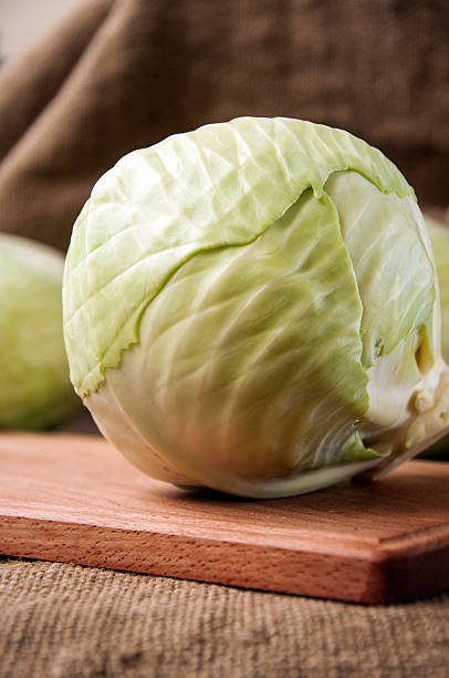 istock cabbage on a wooden board on a background sacking, burlap 496634004