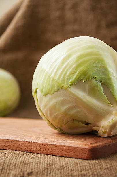 istock cabbage on a wooden board on a background sacking, burlap 496634108