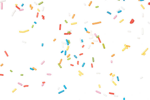 Colorful sprinkles Colorful sprinkles spilled on white background. sugar sprinkles stock pictures, royalty-free photos & images