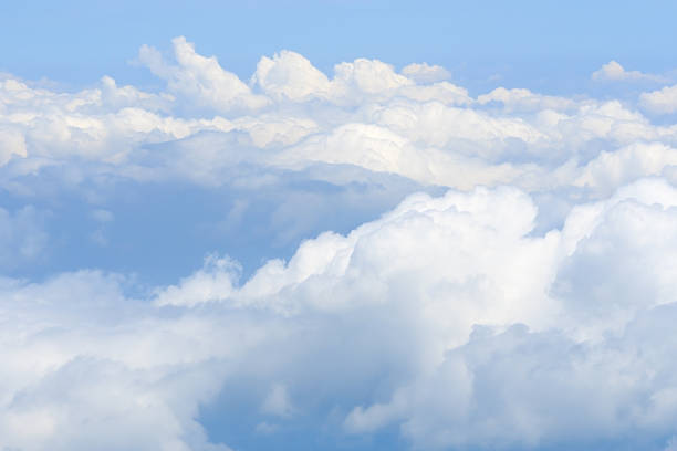 istock Fluffy white clouds and blue sky seen from airplane. 496634832