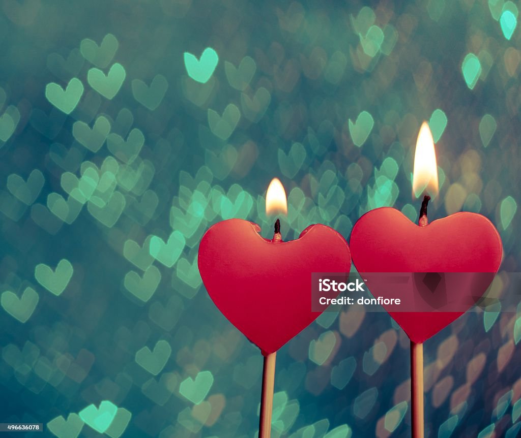 red hearts candles on vintage hearts bokeh as background red hearts candles on vintage hearts bokeh as background, valentine day and love concept 2015 Stock Photo