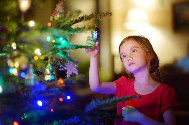 istock Adorable little girl decorating a Christmas tree 496638302