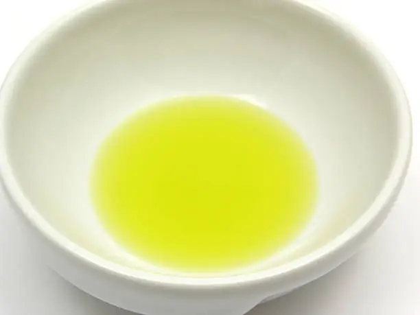 One bowl of chinaware with olive oil in a close-up view