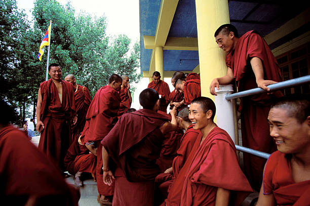 Dharamsala, India - April 26, 2006: Group of smiling Tibetan Buddhists waiting outside to see the Dalai Lama in Dharamsala, India