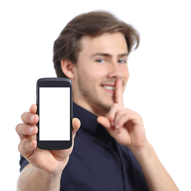 istock Man showing mobile phone screen and asking for silence 496644041