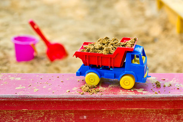 excavator toy on sand, children activity