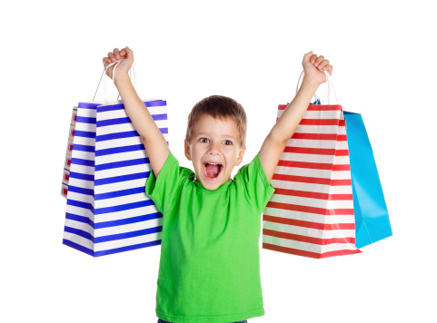 Happy boy with shopping bags, isolated on white