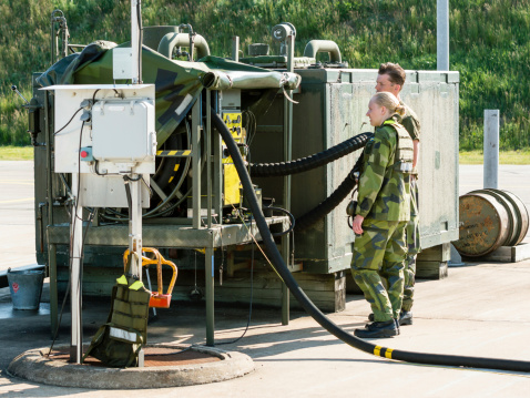 Kallinge, Sweden - June 01, 2014: Swedish Air Force air show 2014 at F 17 Wing. Two soldiers at refueling station for JAS 39 Gripen.