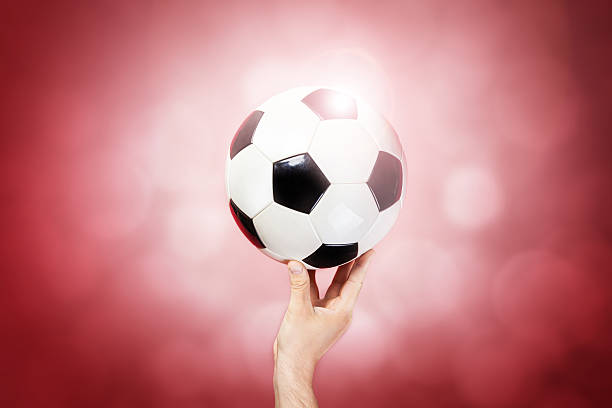 istock Hand hold ball on color background 496647793