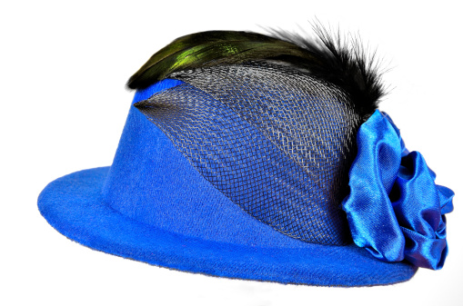 Vintage blue lady's hat with black feathers and textiles decorated,  isolated on white - a carnival costume accessory.
