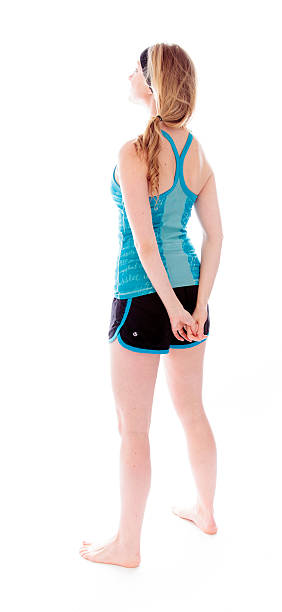 istock Rear view of a young woman standing  hands clasped 496649515