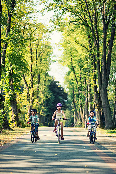istock Kids riding bicycles in park 496650074