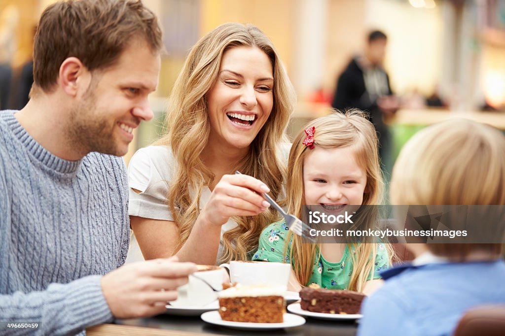 Family Enjoying Snack In Café Together Family Enjoying Snack In Café Together Smiling Family Stock Photo