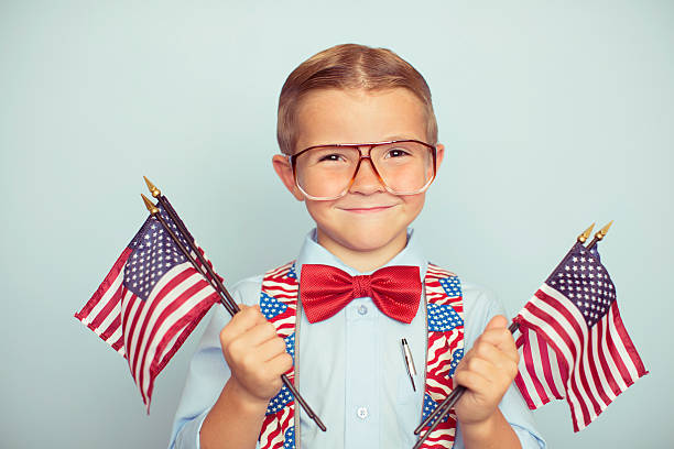 istock Young American Boy Holding Flags on Election Day 496650674