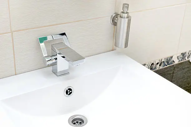 Chromium-plate tap on white sinkChromium-plate tap on white sink