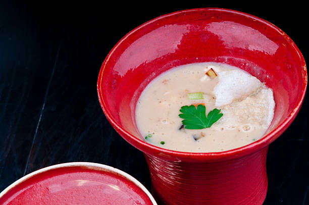 istock Vegetable potage served in a red cup on a table 496651158